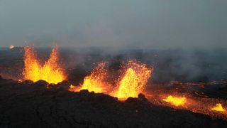 Lava is spewing from a volcano that erupted on Reykjanes peninsula on December 19, 2023 in Grindavik, Iceland. Four distinct burst of lava come out of the ground.