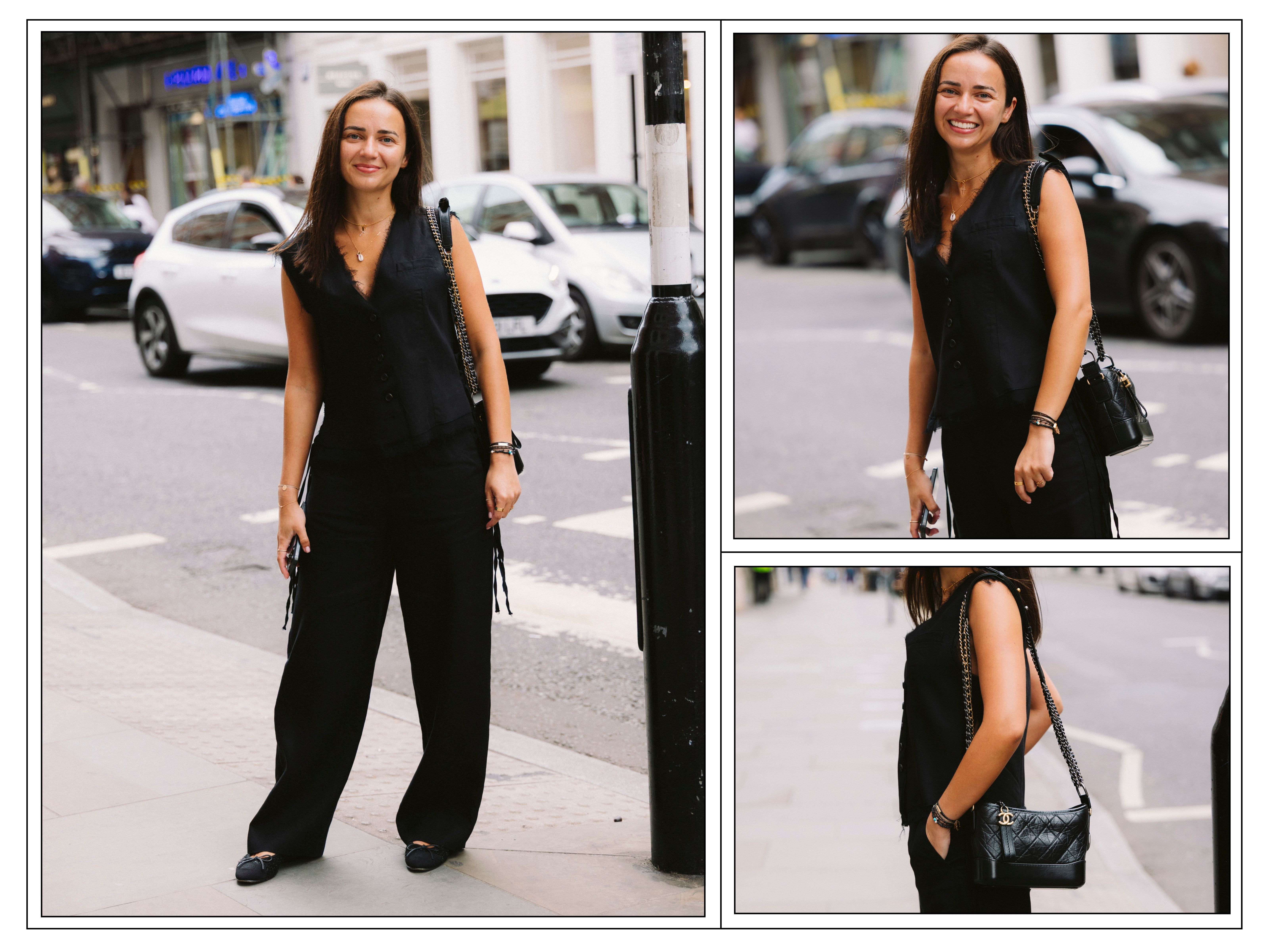A woman wears an all-black, wide-leg trouser and sleeveless top outfit in London