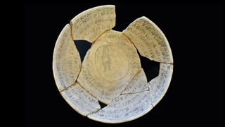 This incantation bowl has an image of what appears to be a demon at the center. Photo by Yoli Schwartz/Israel Antiquities Authority