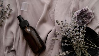 lavender and spray bottle on bed