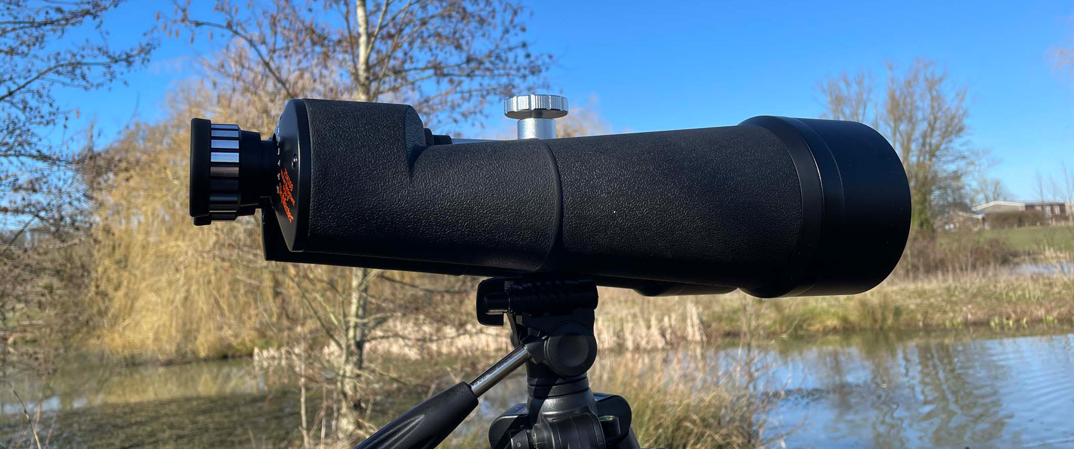 celestron skymaster 25x100 on a tripod outside