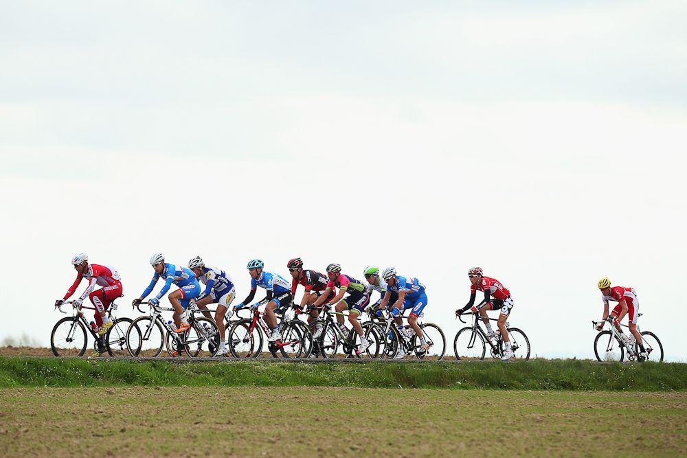 The peloton rides through the Flanders countryside.