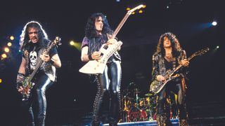 Kiss members (from left) Gene Simmons, Bruce Kulick and Paul Stanley perform live onstage, without make up, May 21, 1992