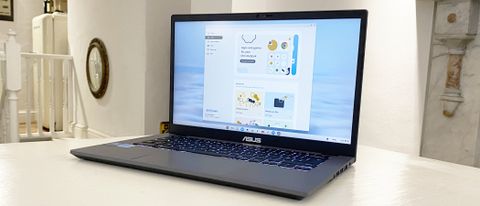 Asus Chromebook Plus laptop on a beige patterned surface