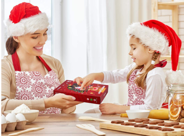 A woman and child smile over an advent calendar.