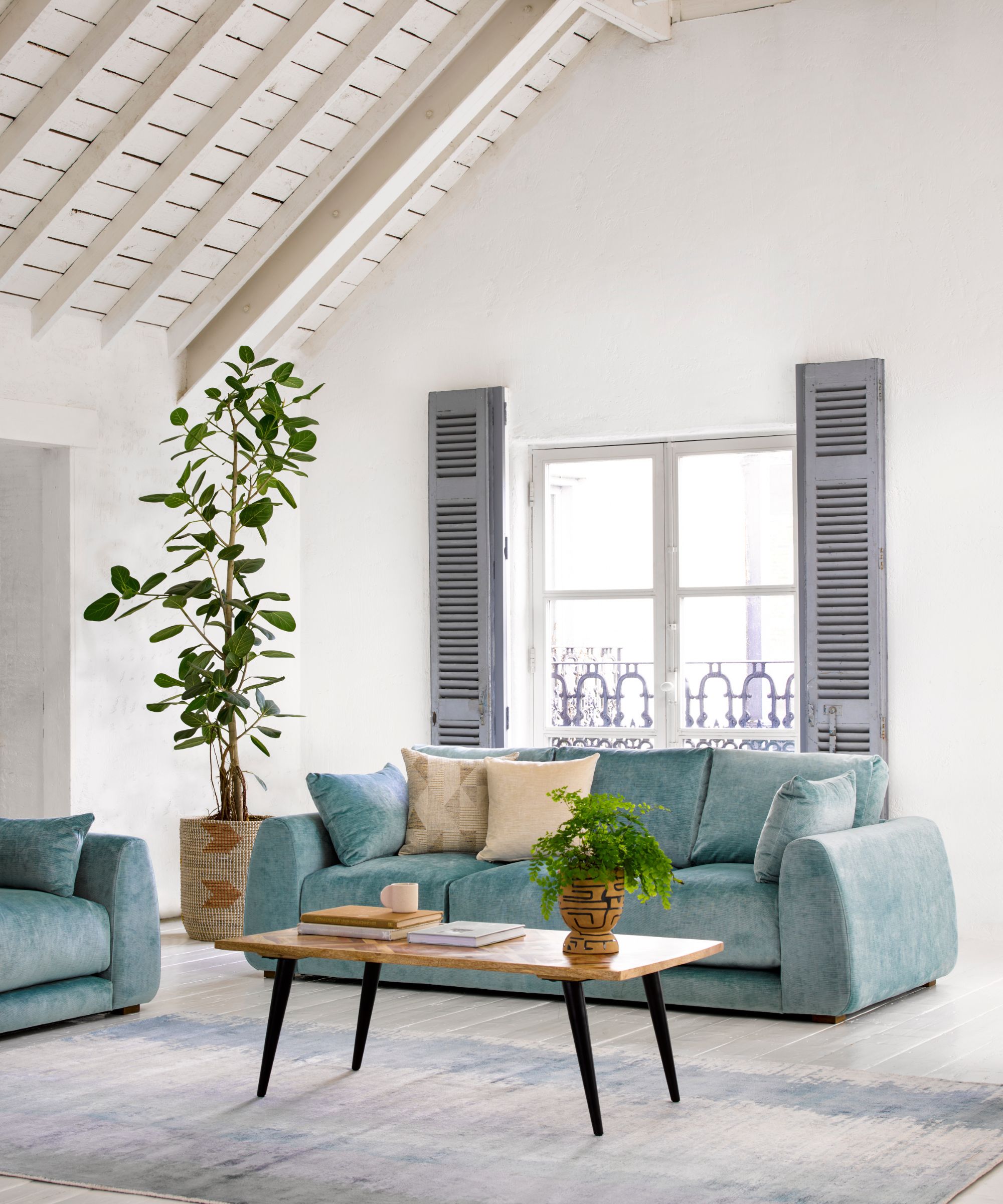 Living room with blue sofa and coffee table in front