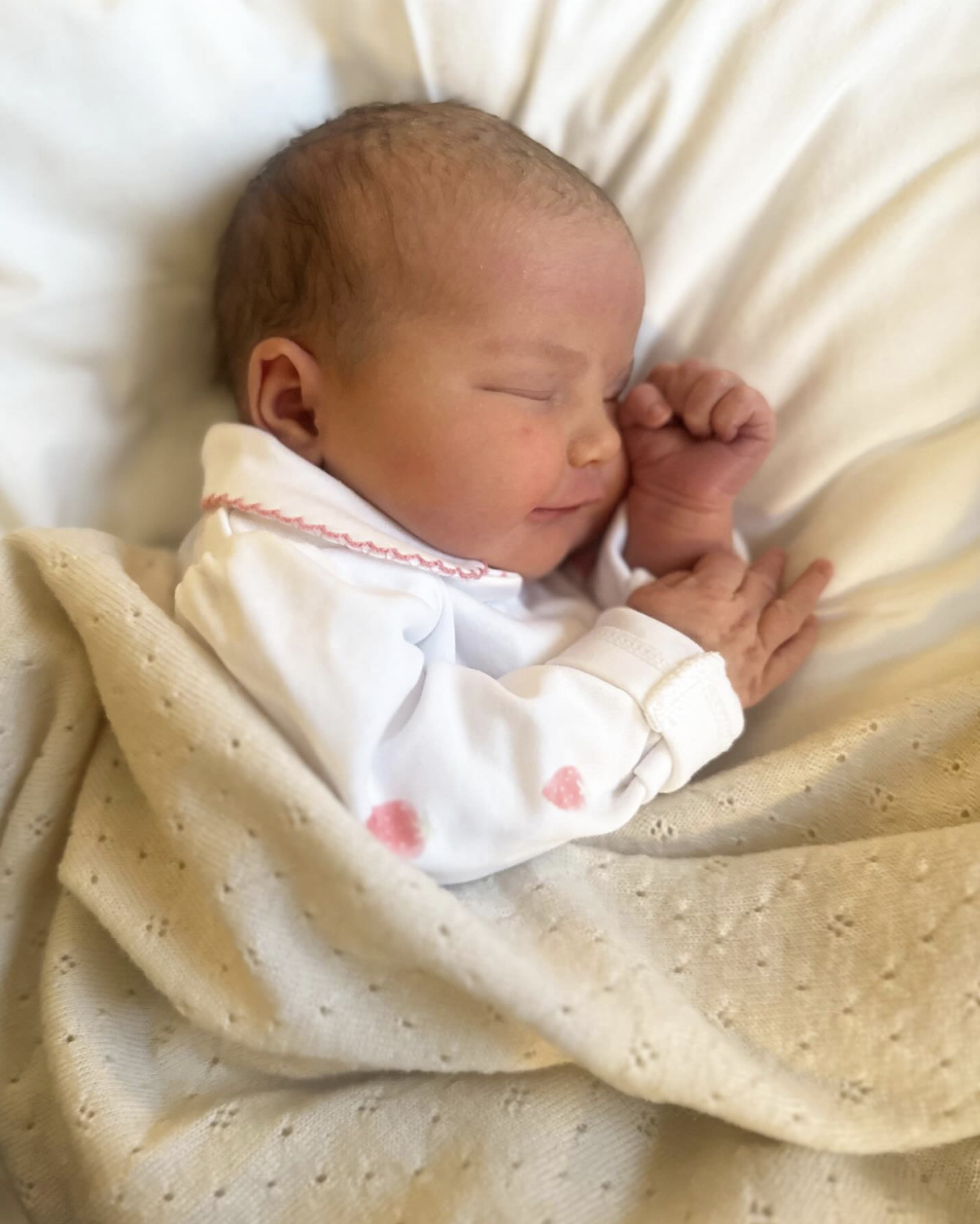 Princess Ines of Sweden in a tan blanket and white sleeper