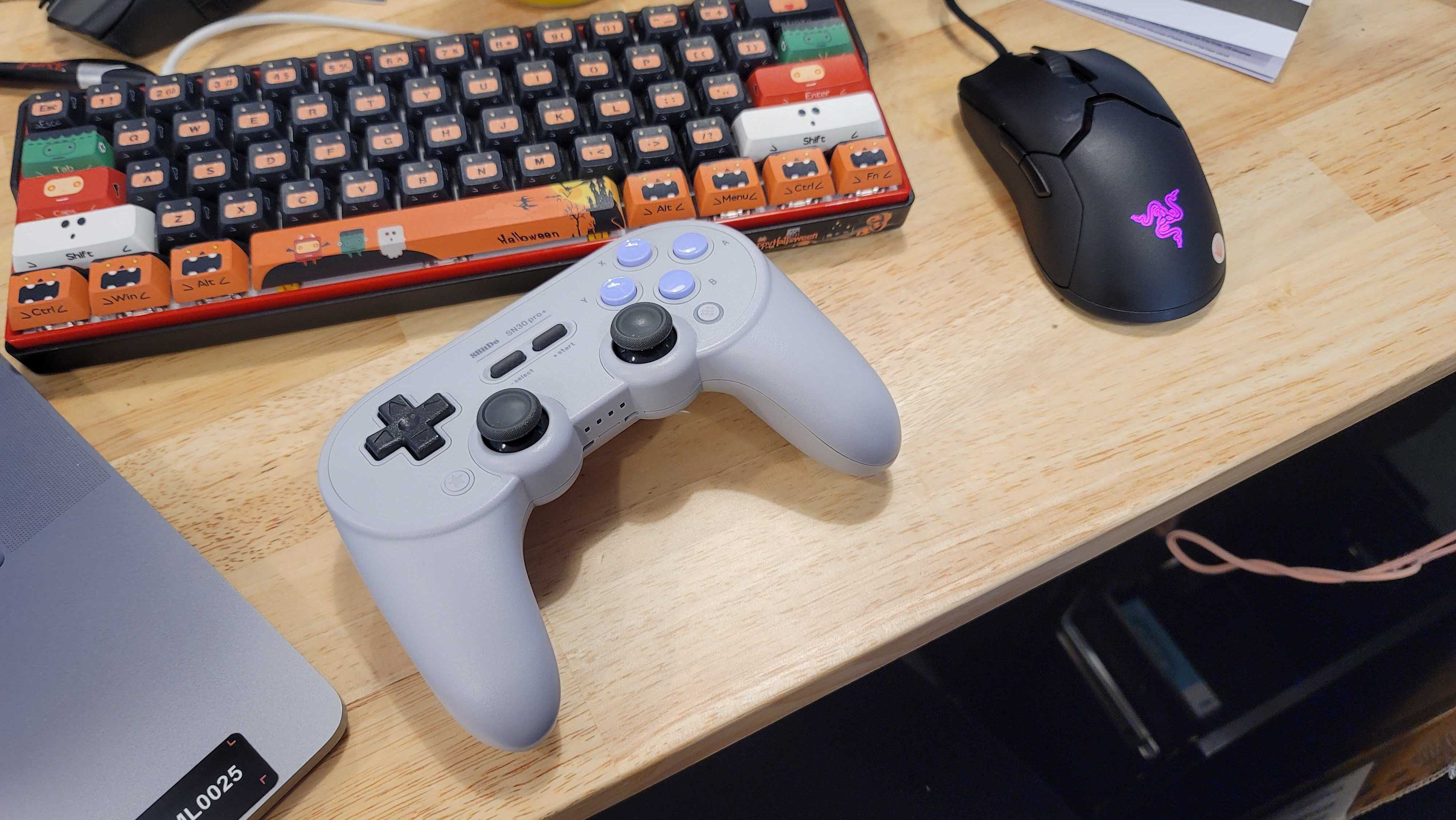 8bitdo sn30 pro on a messy desk