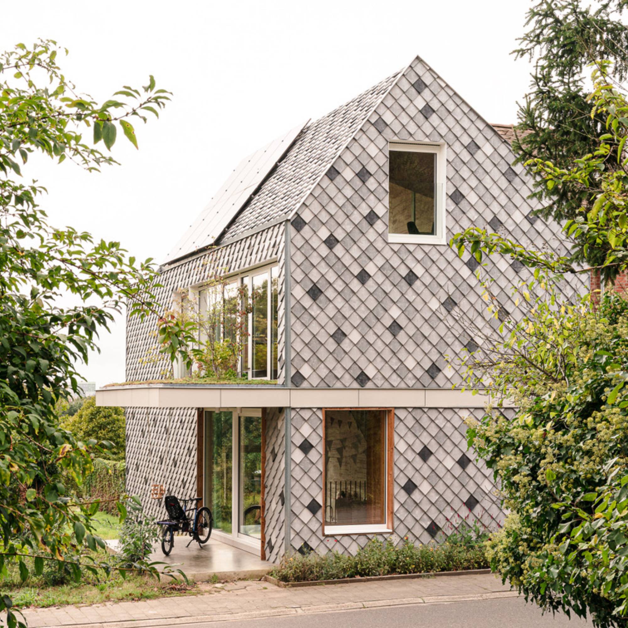 grey plastic cladding on modern house with large windows