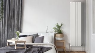 a bedroom with a vertical radiator