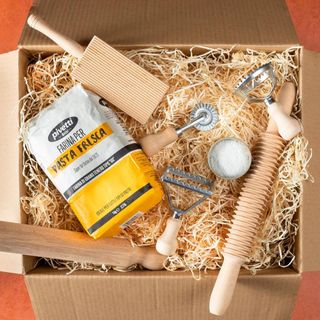 A lifestyle image of the contents of the Pasta Evangelists Ultimate Pasta Making Kit in a box