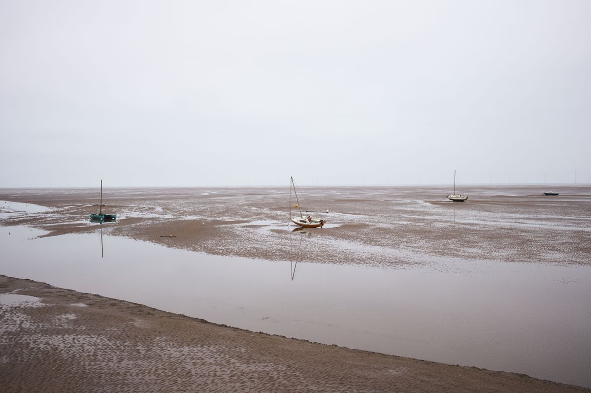 Boats grounded on the sand with the tide out