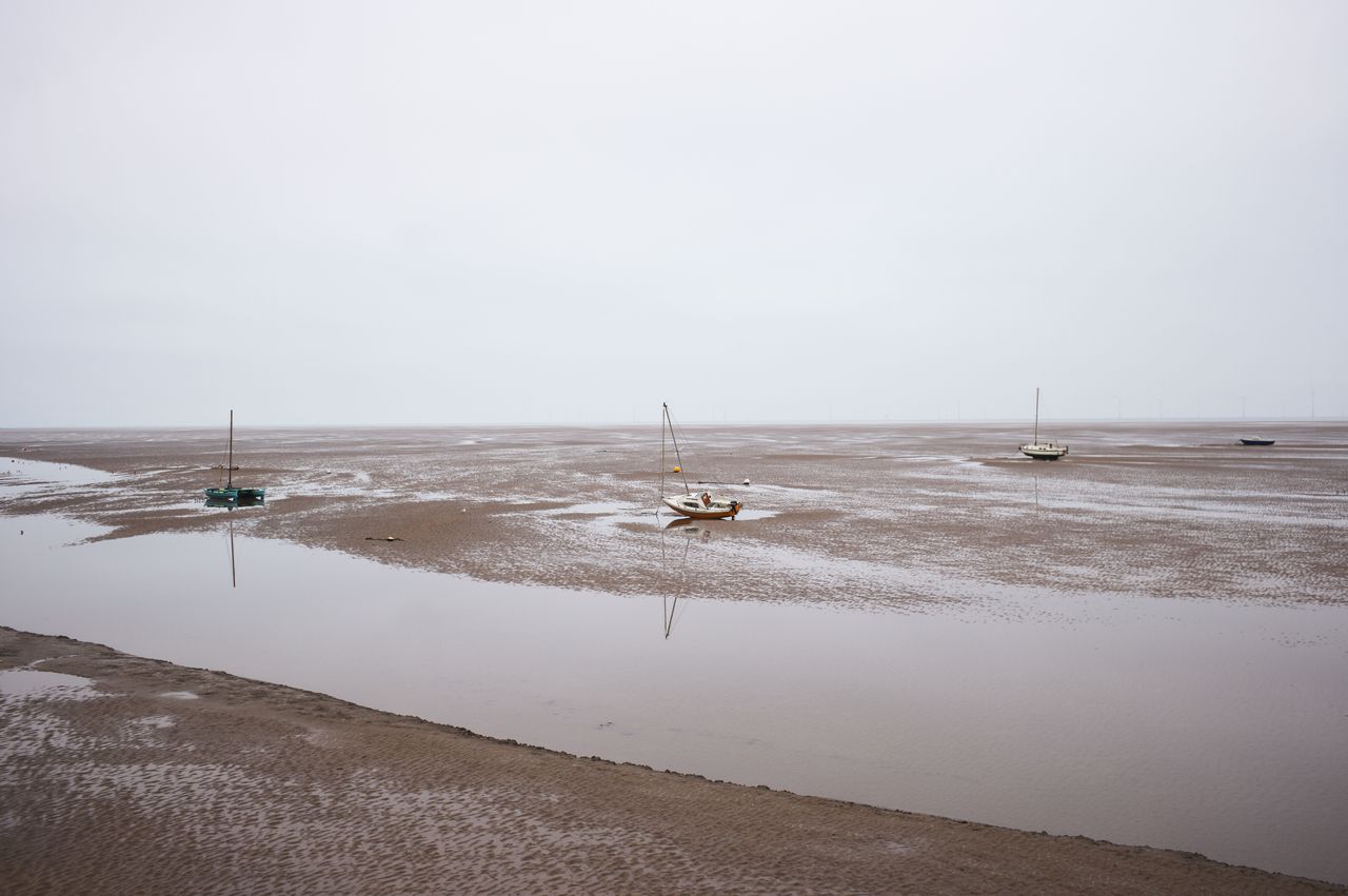 Boats grounded on the sand with the tide out