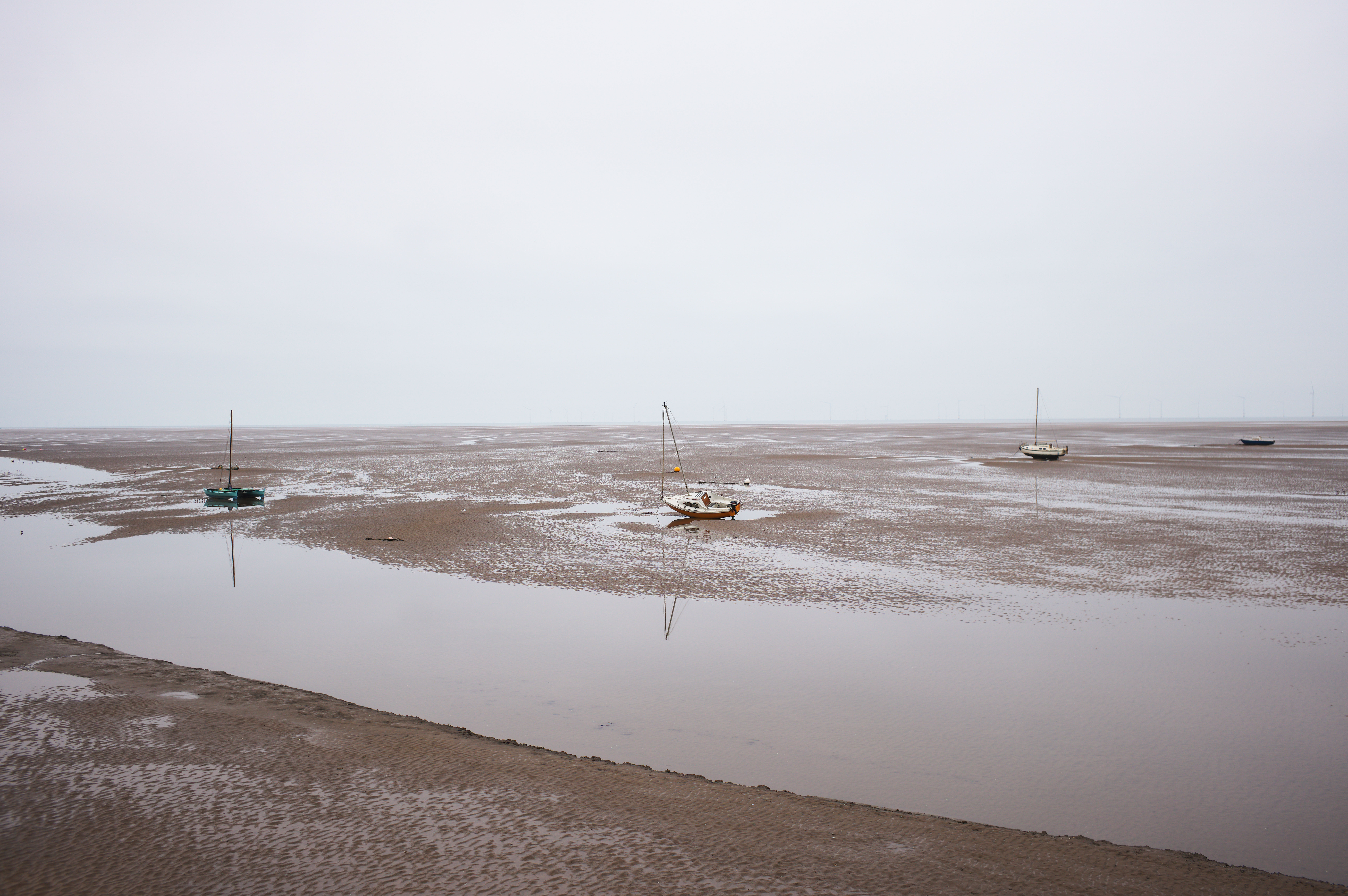 Boats grounded on the sand with the tide out