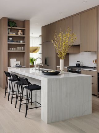modern kitchen with stone island and brown cabinets