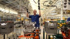 An employee works on an engine production line at a Ford factory