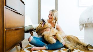 A Golden Retriever cuddling woman