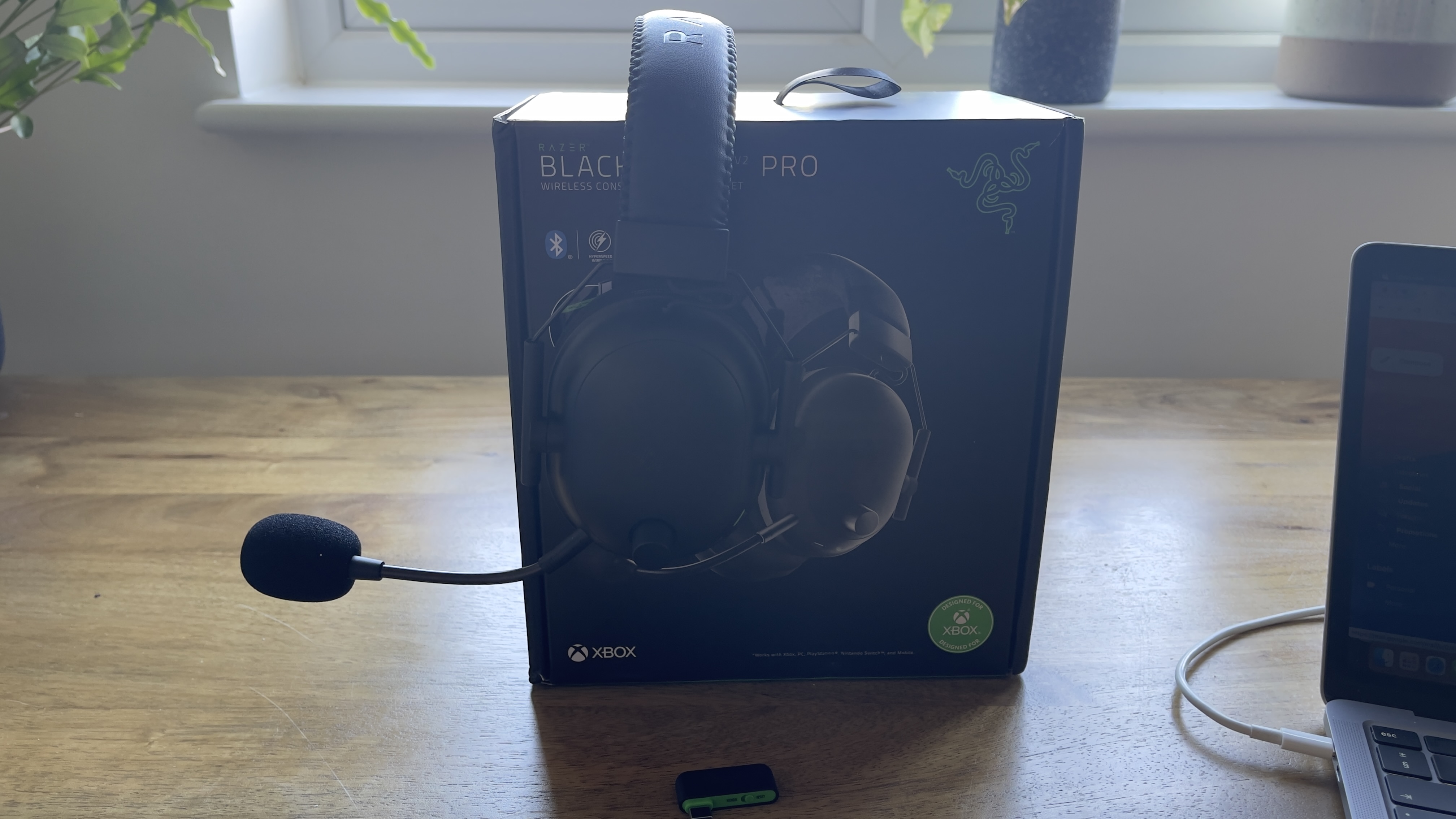 The Razer BlackShark V2 Pro for Console gaming headset on a wooden surface