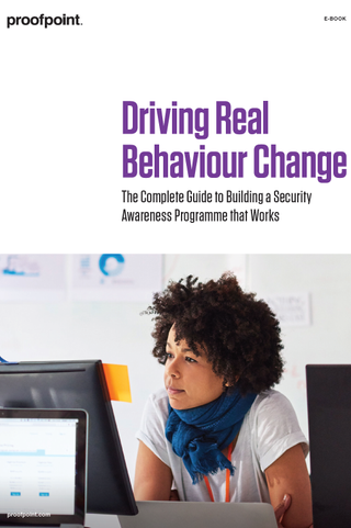 Driving real behaviour change - whitepaper from Proofpoint - woman with scarf sitting at computer