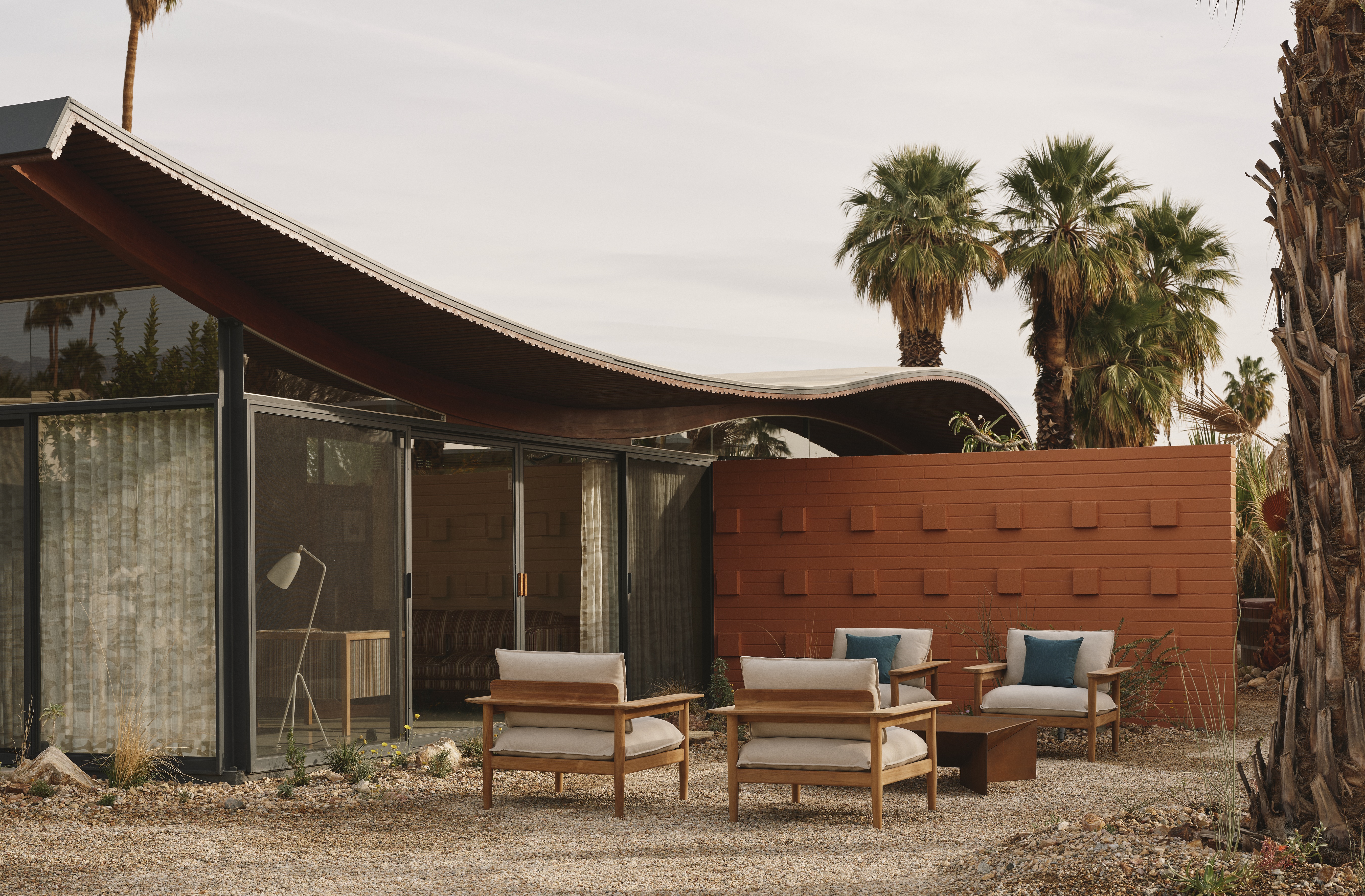 A Californian desert house from the mid 20th-century is furnished with earthy, stripy furnishings and iconic design pieces.