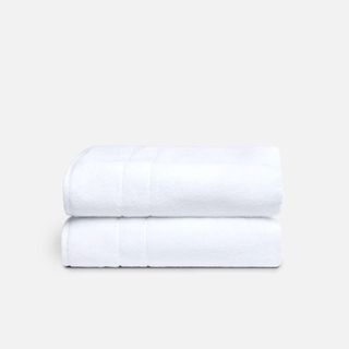 Brooklinen Super Plush Bath Towels against a cream background.