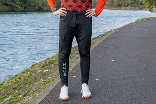 A man wearing Huub heated trousers by a river