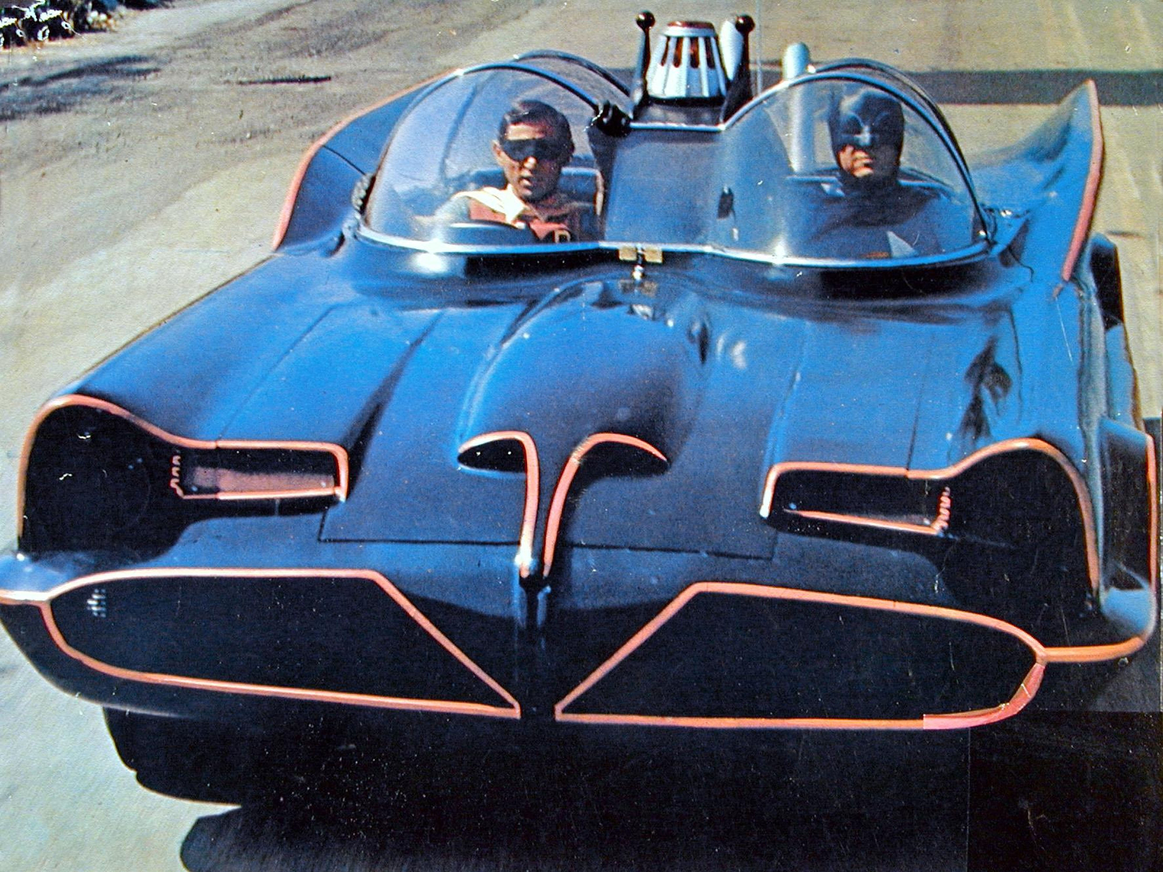 Adam West as Batman and Burt Ward as Robin drive in the Batmobile in the original 1960s TV adaptation of Batman