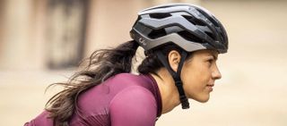 Female cyclist wearing Liv Rev Pro helmet
