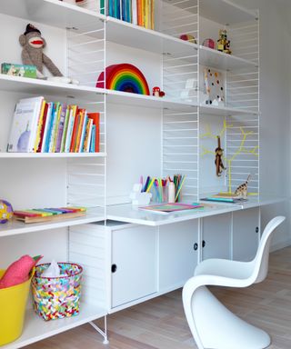 white string shelving system with desk and white curved plastic chair