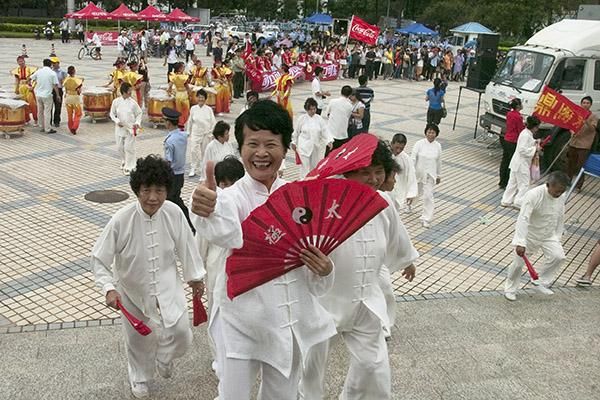 That was cool: Fan-waving performers leave the stage after their performance in Haikou.