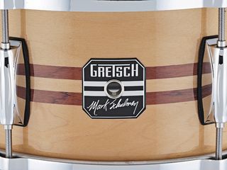 The light natural maple finish features an inlay of two strips of Bubinga.