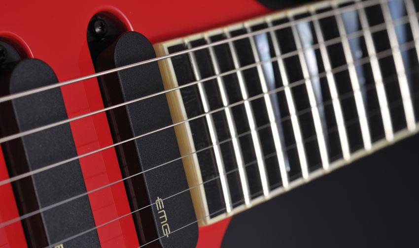 The 24 frets are adorned by mother-of-pearl shark-fin inlays