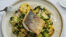 Pan fried sea bass fillet with herbed courgettes