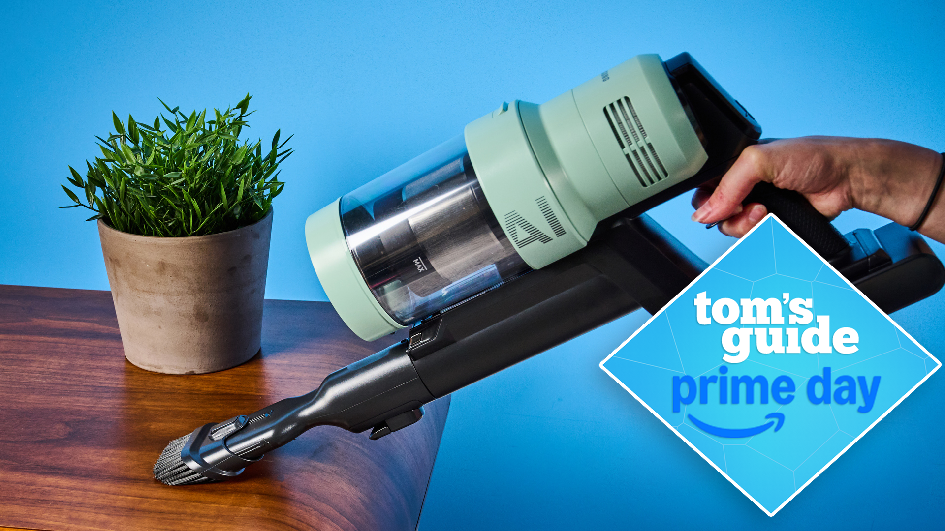 the samsung bespoke jet AI ultra vacuum in the handheld mode, showing it cleaning a table, with a tom&#039;s guide prime day deals badge