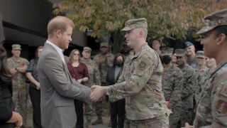 Prince Harry being presented with a gift from the military in Harry & Meghan