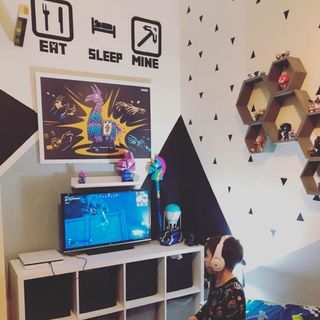 gaming themed bedroom with printed white walls and gaming headphone
