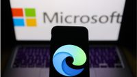 Edge logo displayed on a phone screen and Microsoft logo displayed on a screen in the background are seen in this illustration photo taken in Krakow, Poland on February 7, 2023.