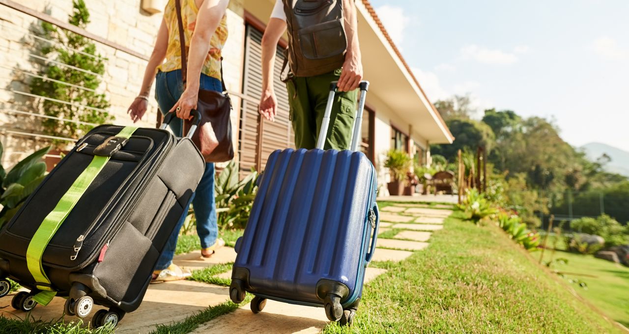 people dragging suitcase