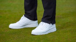 The stunning white Mizuno G-Style Golf Shoes being worn on the golf course