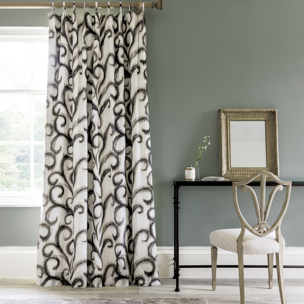 room with grey wall and white window with curtain and chair and mirror
