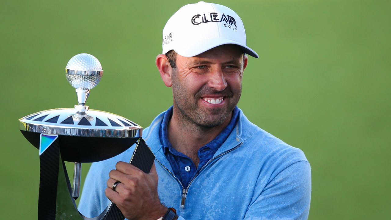 Charl Schwartzel poses with the winner&#039;s trophy after the first LIV Golf Invitational Series event