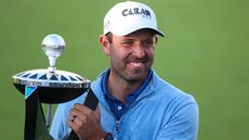 Charl Schwartzel poses with the winner's trophy after the first LIV Golf Invitational Series event