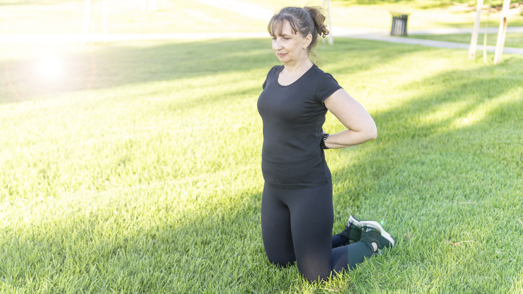Woman kneeling on grass