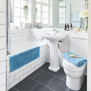 bathroom with white tiles and bath tub