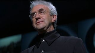 Jonathan Pryce smiles during a press conference in Tomorrow Never Dies.