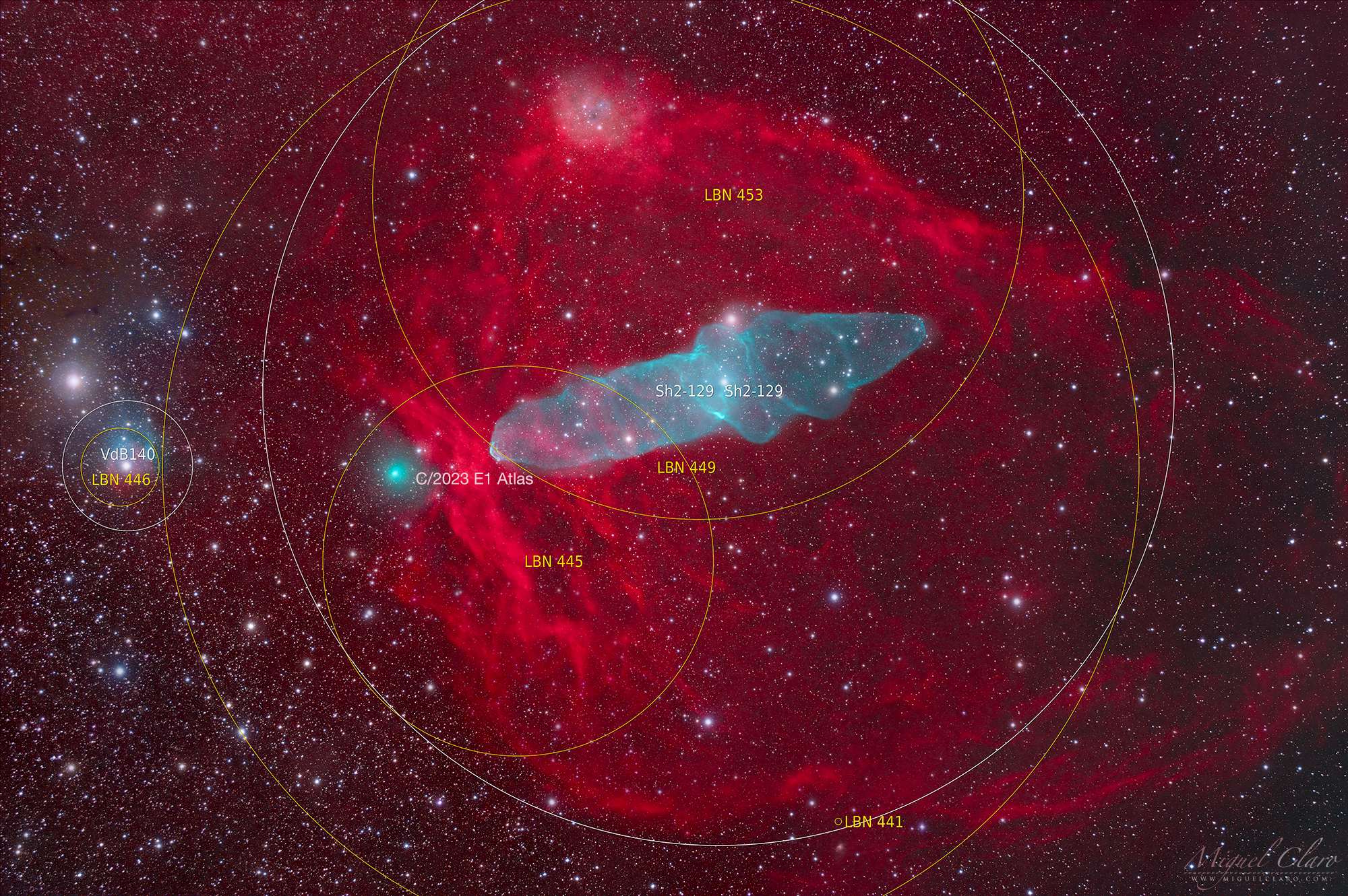 a large red gaseous looking cloud of dust and gas surrounds a blue hued cloud shaped like a squid. to the left of the squid is a greeny blue sphere of light.