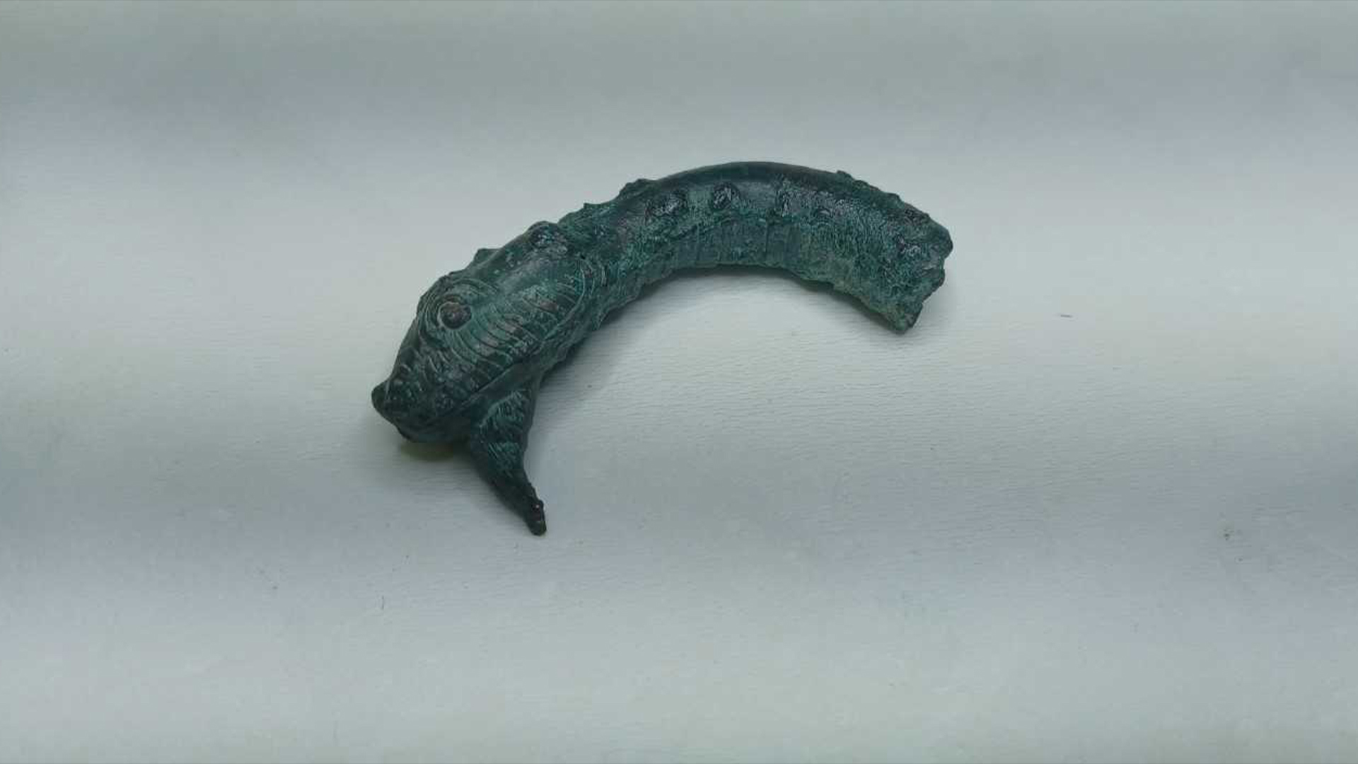 A bronze serpent head, likely from a scepter, that archaeologists found at the site.