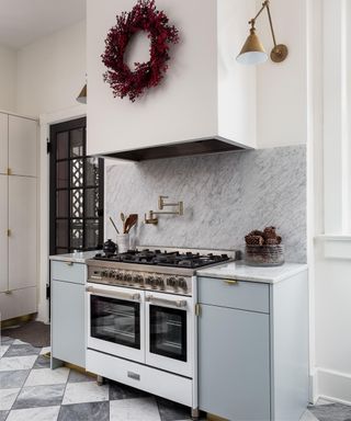 White kitchen with red wreath above stove
