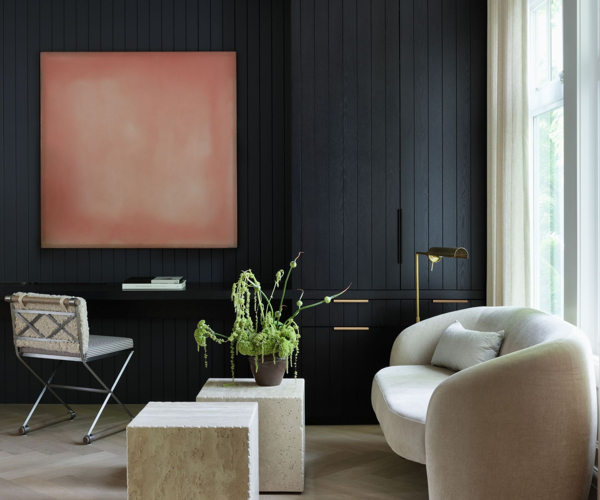 study with dark walls and white sofa