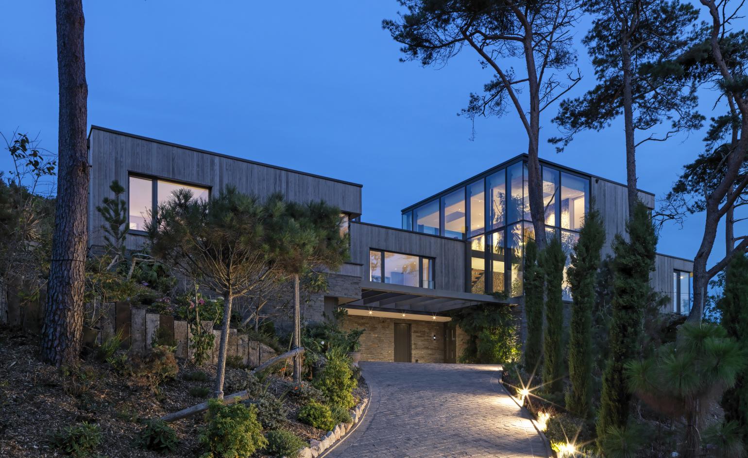 house exterior with windows and surrounding trees